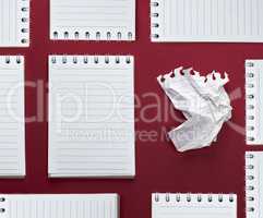 abstract red background with many notebooks with blank sheets i