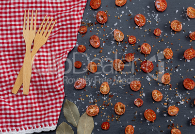 fork on a red napkin and a half of red cherry tomatoes