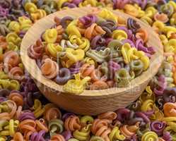 multicolored spiral raw pasta fusilli