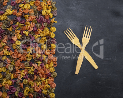 pasta multicolored spiral of wheat flour on a black background