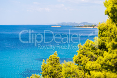 Sunny beautiful summer sea view with Greek blue sea and shallow