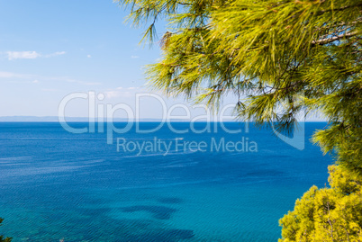 Sunny beautiful summer sea view with Greek blue sea and shallow