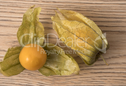 Physalis fruit (Physalis Peruviana) with husk on wooden backgrou