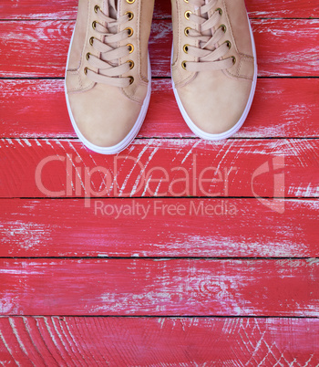 pink pair of female leather sneakers with laces