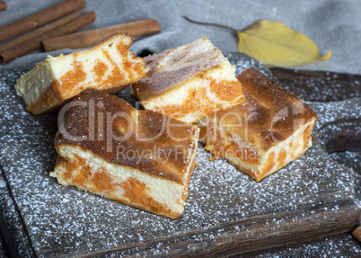 baked square pieces of pumpkin cheesecake