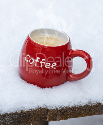 red ceramic mug with black coffee