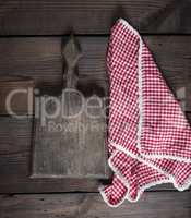 old kitchen cutting board with handle and red towel