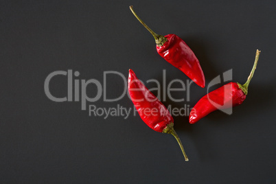 Red hot chili peppers over a dark background