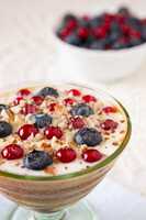 Closeup of a yogurt dessert with berries and almonds