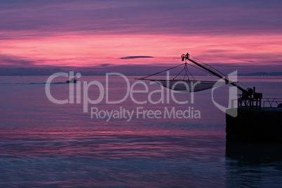 Wonderful magenta sunrise from the pier of Senigallia, Italy