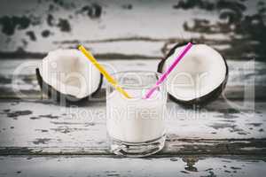 Coconut milk in a glass with two straws