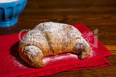 Croissant over a red napkin