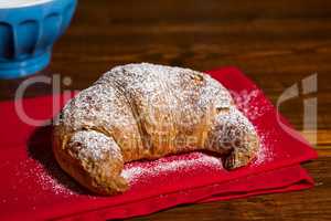 Croissant over a red napkin