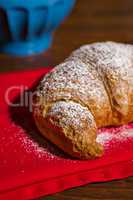 Closeup of a croissant over a red napkin