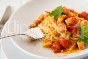 Closeup of spaghetti with fish and little tomatoes