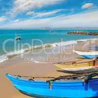 Fishing boat on the sandy shore against a background the ocean a