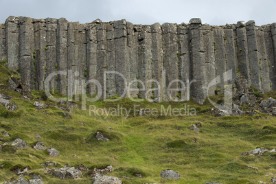Wall of high basalt columns in Iceland.