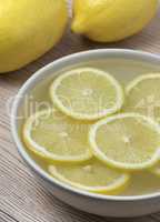 Lemon slices in a bowl with water.