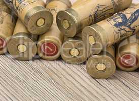 Hunting cartridges of 12 gauge for shotgun on wooden background.