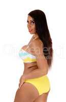 Beautiful woman standing in a bikini in profile