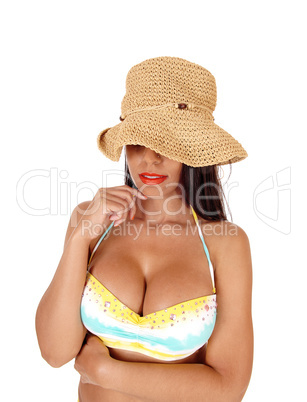 Mystery woman with straw hat in close up in bikini