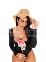Gorgeous woman standing in a black bodysuit with a rose