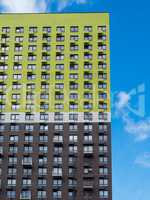 Bright modern facade of a house with a variety of windows and ba