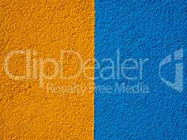 The texture of the plastered facade in two colors blue and yello
