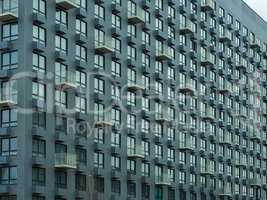 Bright modern facade of a house with a variety of windows and ba