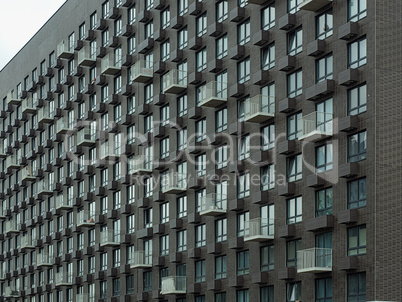 Bright modern facade of a house with a variety of windows and ba