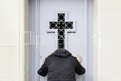 Woman praying in a cemetery