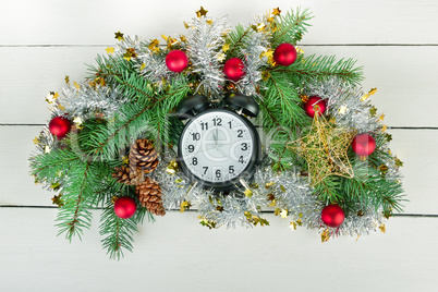 Christmas wreath of fir branches, clocks and bright balls.