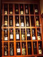 Wine bottles lined up and displayed in a wine cellar.