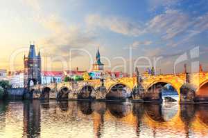 Charles bridge over Vltava river in Prague at sunrise