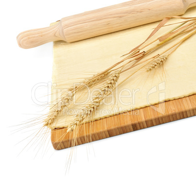 Wheat ears, rolled dough and rolling pin isolated on white backg