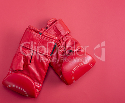 red sport leather boxing gloves on a red background