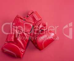 red sport leather boxing gloves on a red background
