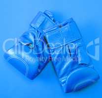 blue sport leather boxing gloves on a red background