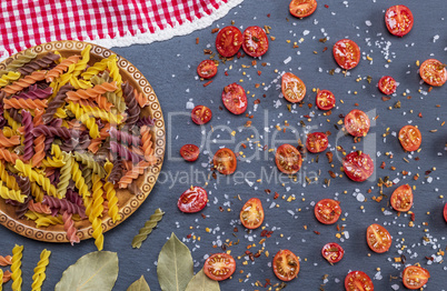 unprepared multi-colored pasta spiral made from wheat flour