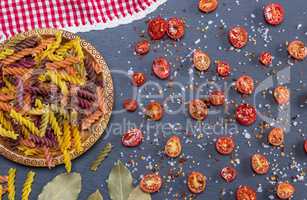 unprepared multi-colored pasta spiral made from wheat flour