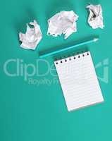 notebook with empty white sheets,  crumpled paper sheets