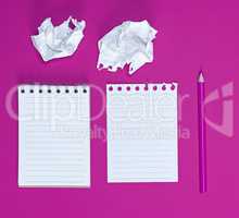 notebook with empty white sheets, two crumpled paper sheets