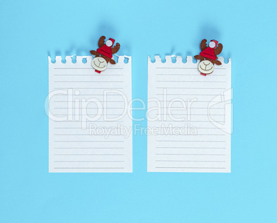 two white blank sheet in a line torn out of notepad