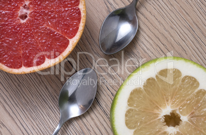 Green Sweetie or Pomelit and Red Grapefruit on wooden background