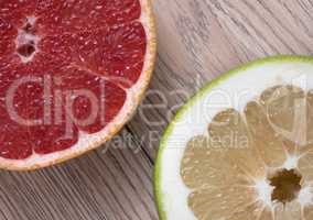 Green Sweetie or Pomelit and Red Grapefruit on wooden background
