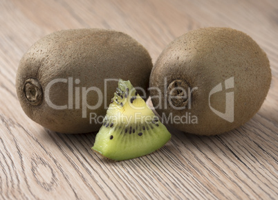 Ripe juicy kiwi fruit on wooden background.