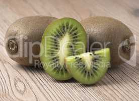 Ripe juicy kiwi fruit on wooden background.