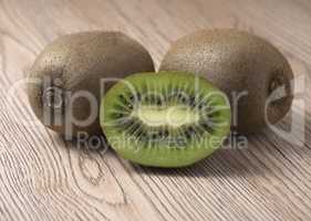 Ripe juicy kiwi fruit on wooden background.