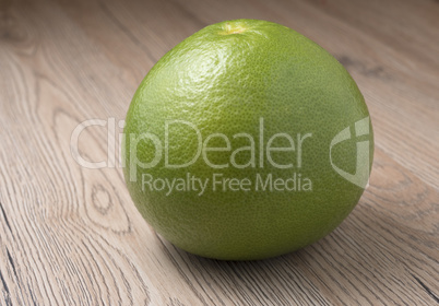 Whole Green Sweetie on wooden background.