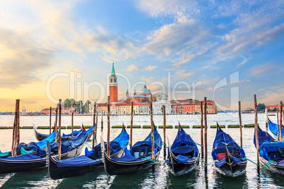 Gondolas moored at the pier in Grand Canal with San Giorgio Magg